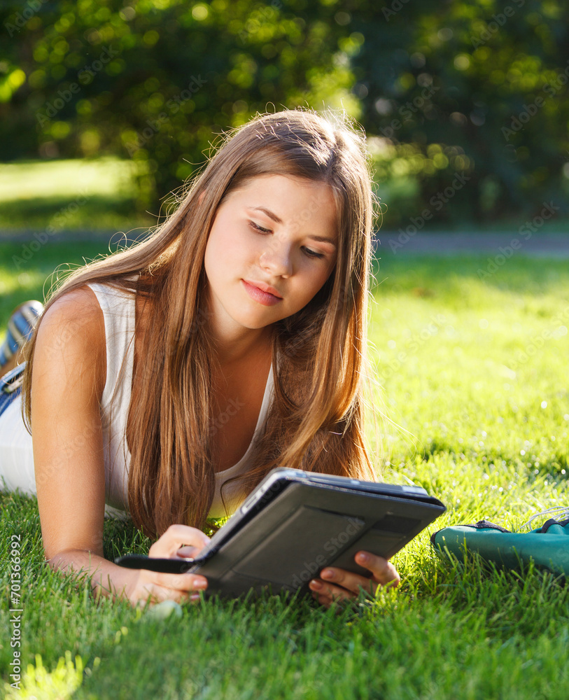 Happy young girl using a tablet computer Happy young girl using a tablet computer