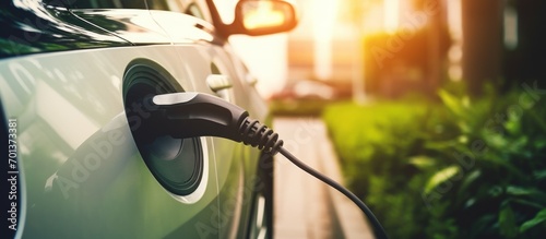 Generic electric vehicle EV hybrid car is being charged from a wallbox 
