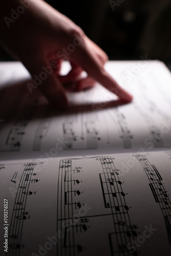 Pointing at sheet music