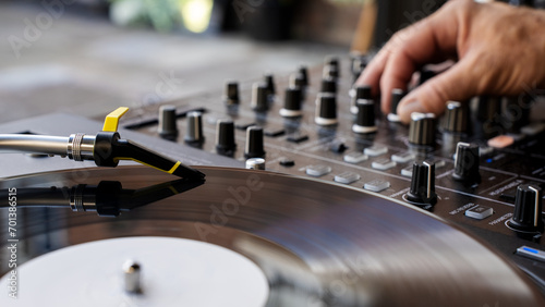 A DJ moving a fader on a mixing console	
