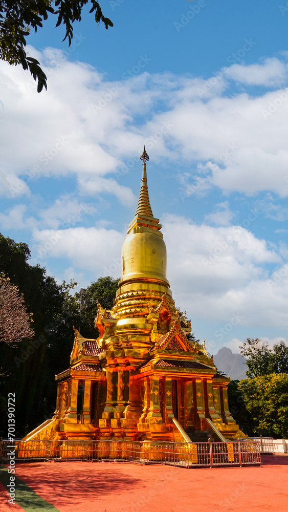 Fototapeta premium Golden Pagoda in Thakhanun temple of Kanchanaburi Province,Thailand.Thailand travel concept.Vertical.