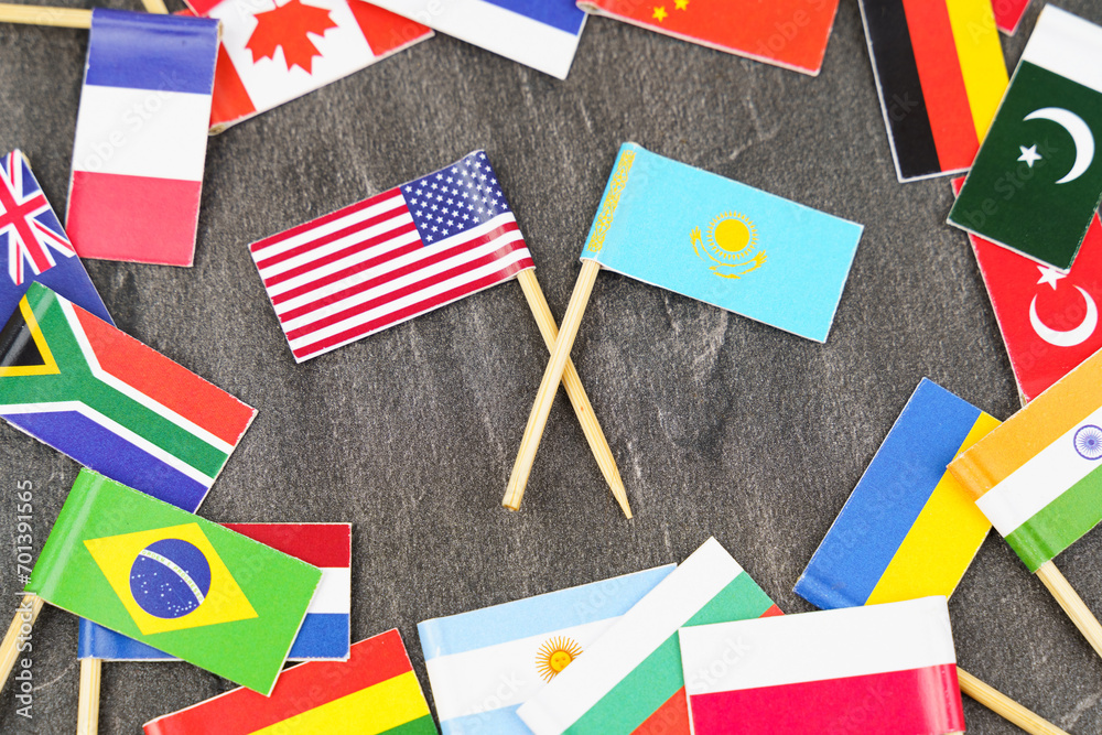 Fototapeta premium The concept is diplomacy. In the middle among the various flags are two flags - USA, Kazakhstan