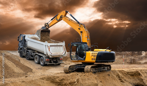excavator is in work and digging at construction site photo