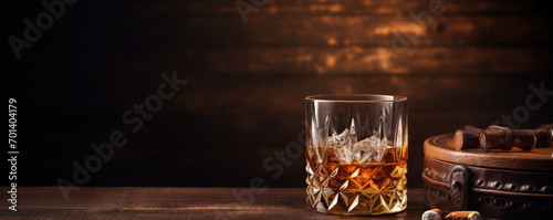 Whiskey glass on wooden table with luxury cigar. Alcohol cognac and cubanian cigar.