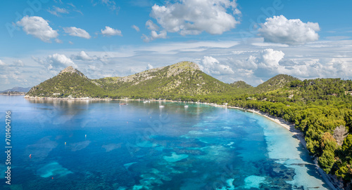 Aerial view Cala Formentor serene beauty, with its white sands, clear turquoise waters, and lush pine backdrop—a tranquil, picturesque escape in Mallorca.