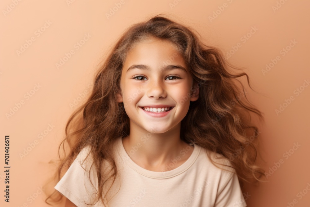 Portrait of a cute little girl with long curly hair on a beige background Portrait of a cute little girl with long curly hair on a beige background