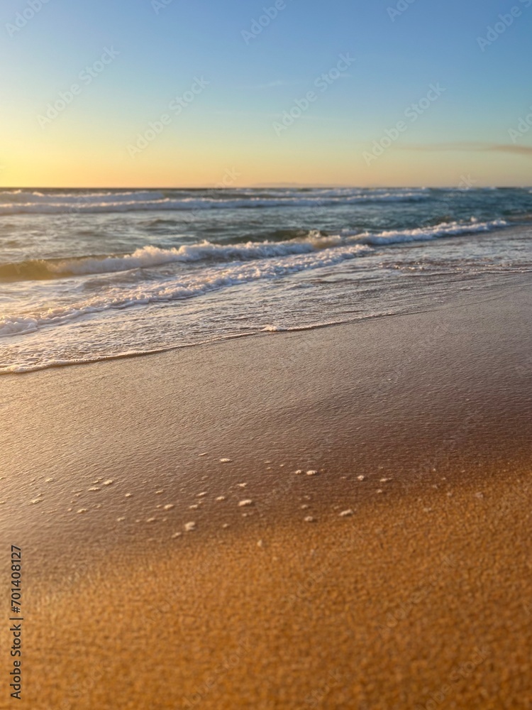 warm light of the sunset sun at the ocean shore, sandy beach warm light of the sunset sun at the ocean shore, sandy beach