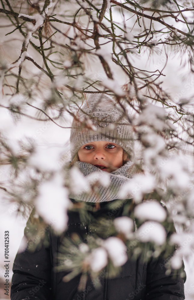 Portrait of a boy in a snowy forest