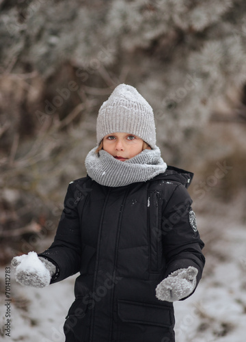 Portrait of a boy in a snowy forest