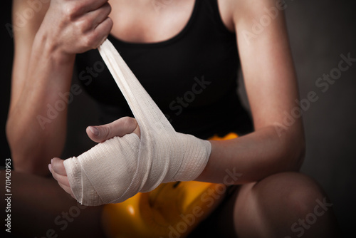 Female boxer wearing white strap on wrist