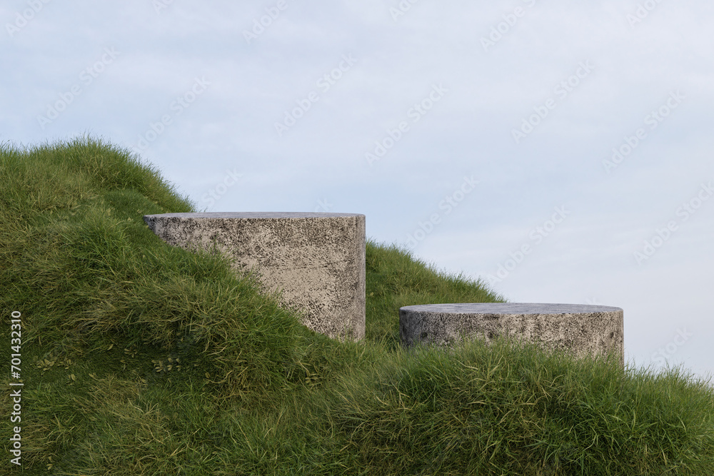 Abstract 3d render platform background,  Stone podium on evergreen grass field mountain for product stand display, advertising, cosmetic, mockup or etc
