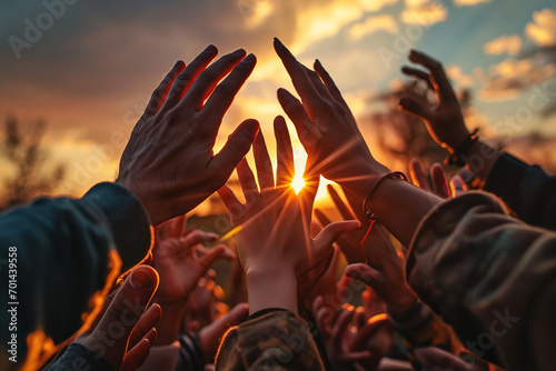 Powerful image capturing diverse hands reaching together towards the sunset, symbolizing unity diversity and collective hope. Ai genrated photo
