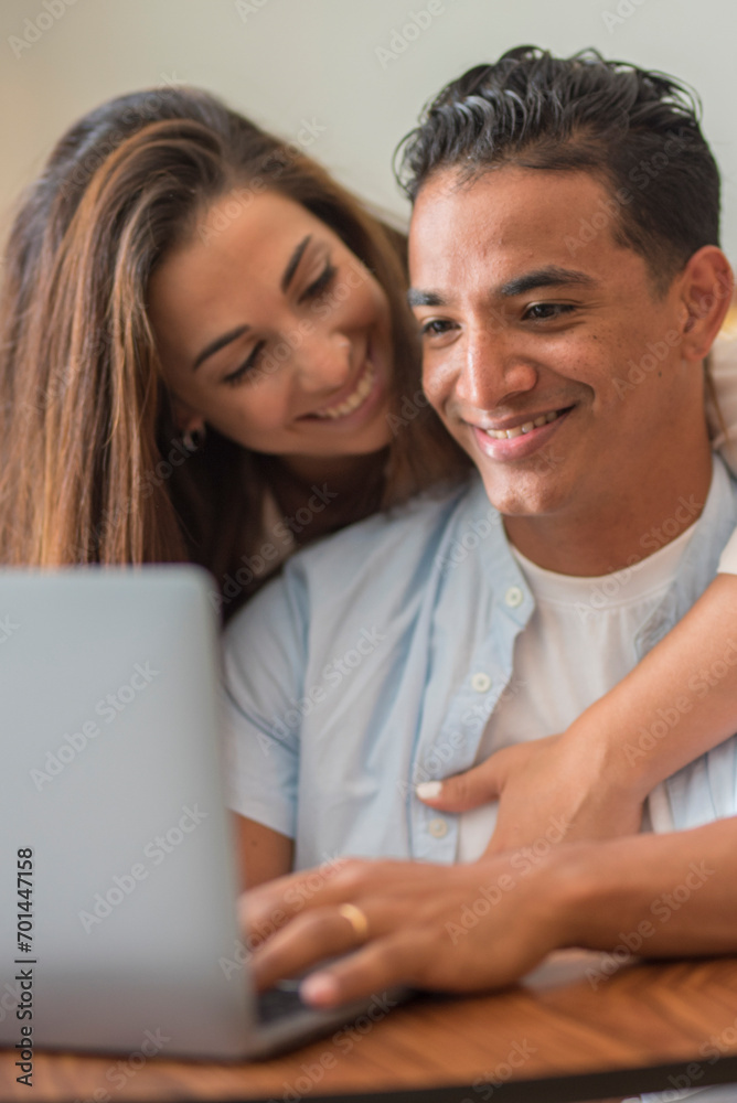 Young interracial couple relaxing on sofa with laptop. People in love and happiness leisure lifestyle at home together - Man and woman enjoy computer and online modern work Young interracial couple relaxing on sofa with laptop. People in love and happiness leisure lifestyle at home together - Man and woman enjoy computer and online modern work