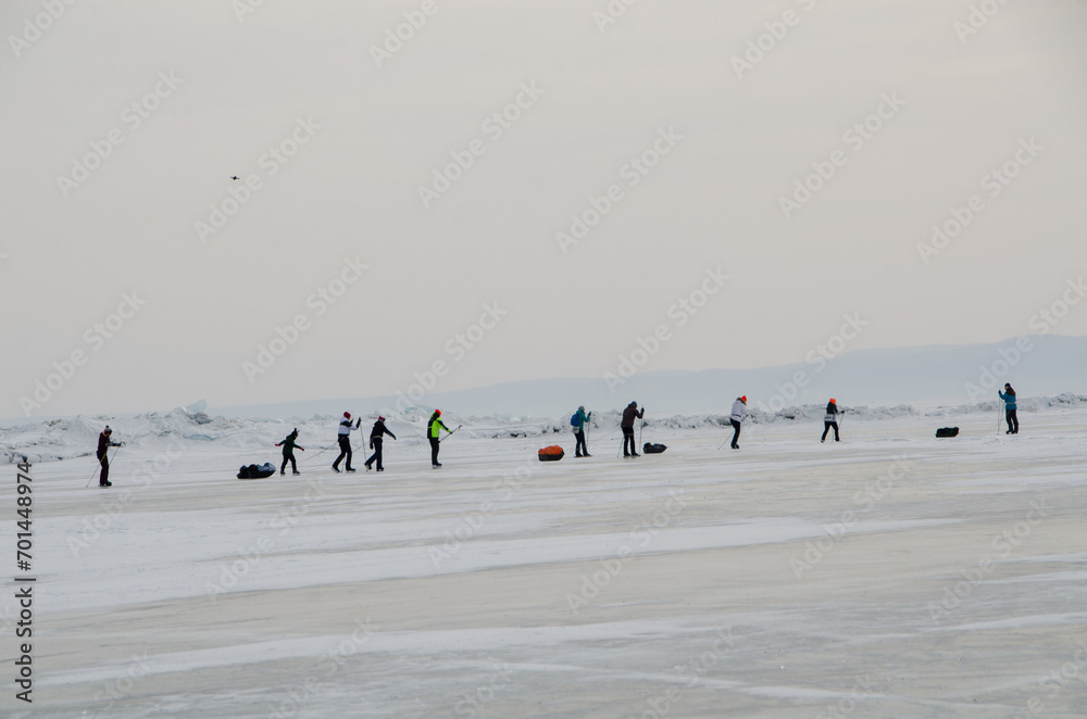 People going skating on frozen lake Baikal. Winter activity in Baikal