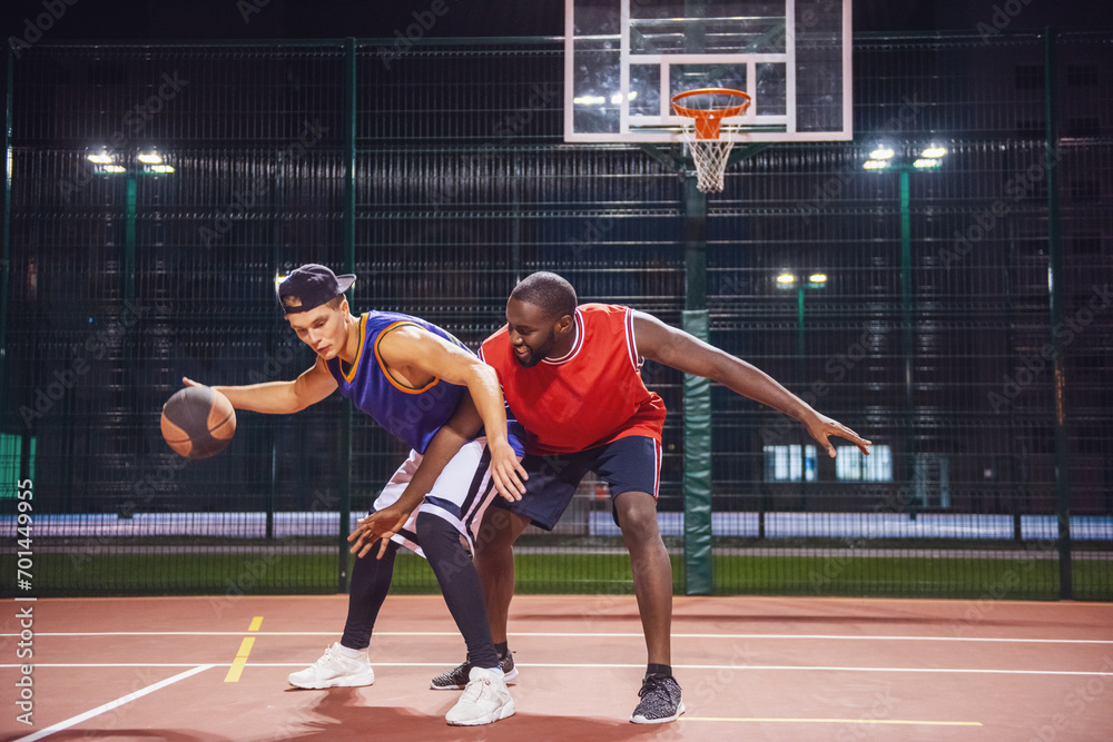 Guys playing basketball