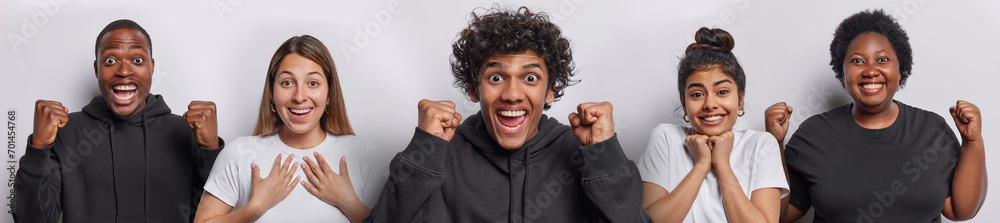 Horizontal shot of amazed cheerful Hindu man with curly hair and dark skinned guy clench fists celebrate success smile gladfully and react to something incredible isolated over white background - obrazy, fototapety, plakaty 