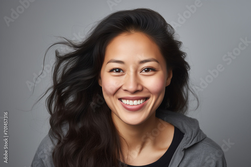 A photo portrait of a beautiful mongolian woman over 30 years old  smiling with clean teeth  perfect teeth. Highlighted on a white background  copy space