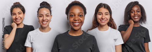 Five diverse young women smile gladfully show perfect teeth express happiness look directly at camera wear casual t shirts glad to hear good news isolated over white background. Collage image