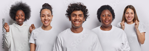 Horizontal shot of happy curly haired Hindu man poses among four happy women rejoice good news expresses positive sincere emotions dressed casually isolated over white background. Collage image