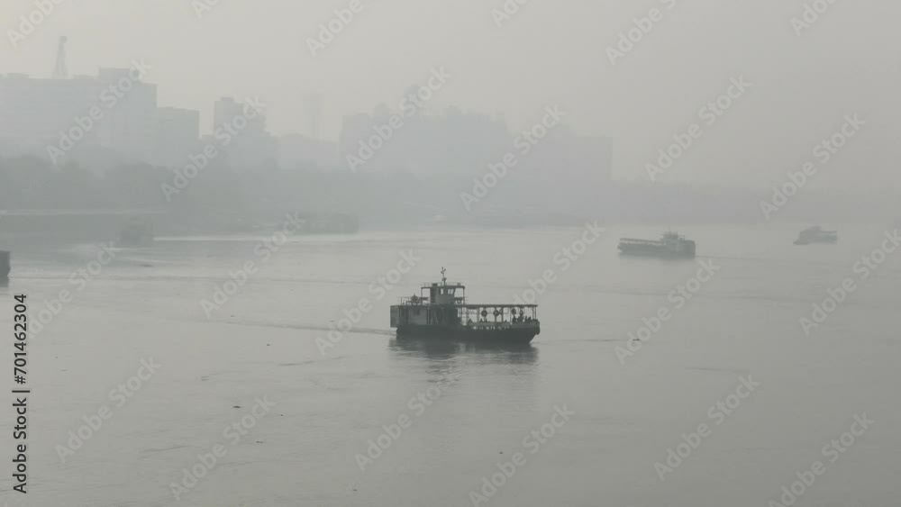 Misty morning view of Hooghly River from Howrah Bridge in Kolkata, West Bengal, India