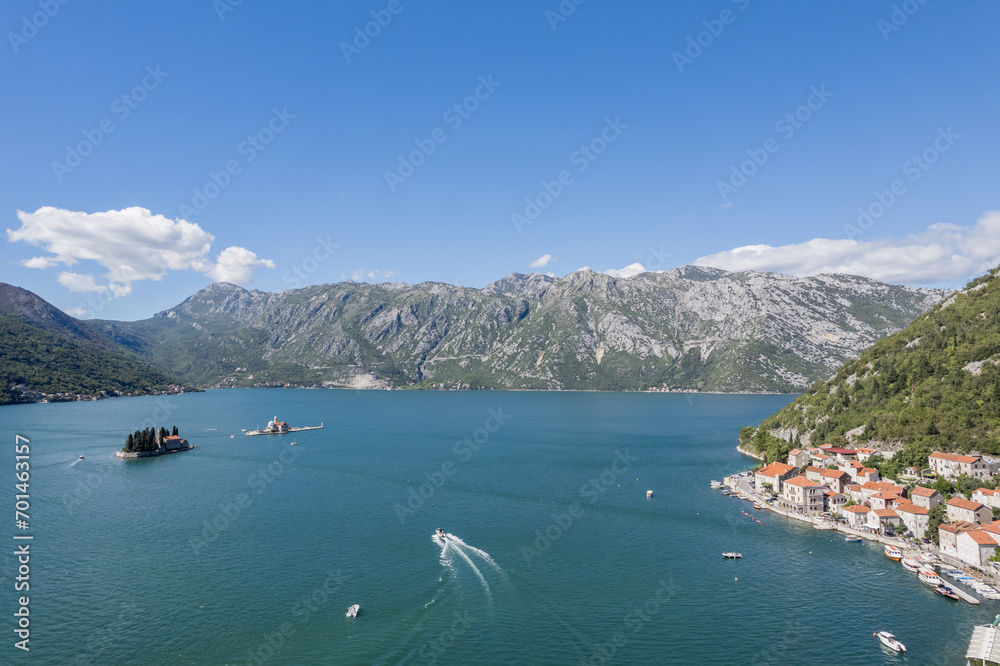 Motor boat sails along the Bay of Kotor to the island of St. George. Montenegro. Drone