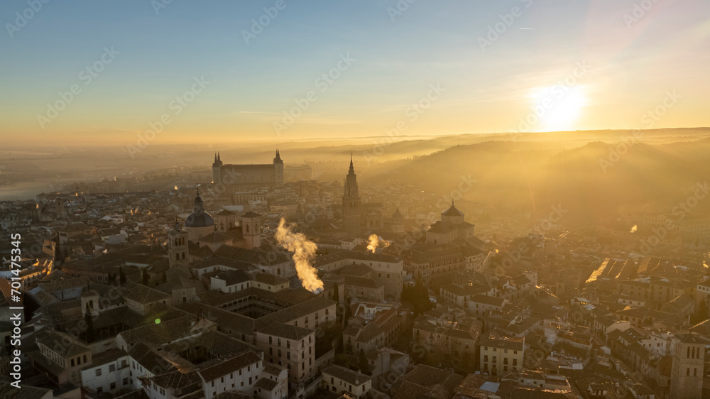 Aerial views of the Alcázar of Toledo during sunrise with sun rays, on a winter day with haze, drone, uas