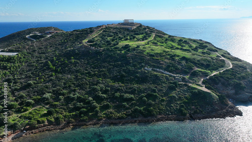 Aerial drone photo of iconic archaeological site of Cape Sounio and famous Temple of Poseidon built uphill overlooking Aegean sea, Attica, Greece
