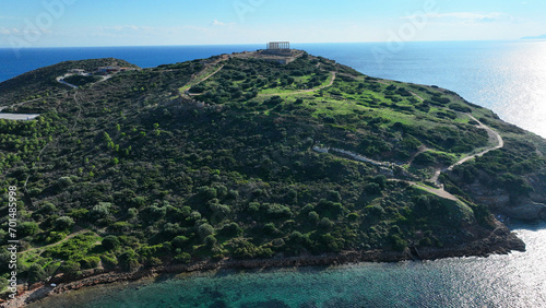 Aerial drone photo of iconic archaeological site of Cape Sounio and famous Temple of Poseidon built uphill overlooking Aegean sea, Attica, Greece