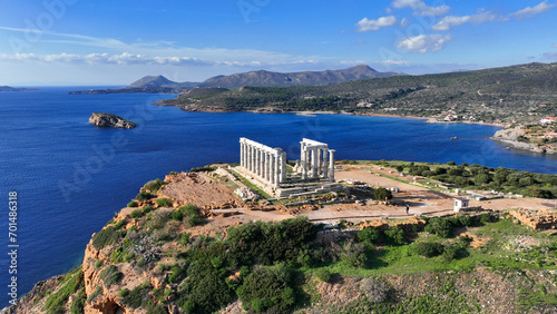 Aerial drone photo of iconic archaeological site of Cape Sounio and famous Temple of Poseidon built uphill overlooking Aegean sea, Attica, Greece