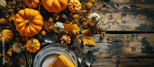 Thanksgiving Table Setting top view banner Autumnal holiday decorated table with pumpkins cutlery yellow leaves. Creative Banner. Copyspace image photo