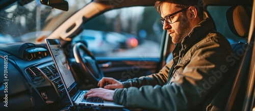 young mining engineer doing calculations in his laptop in a 4x4 car. Creative Banner. Copyspace image