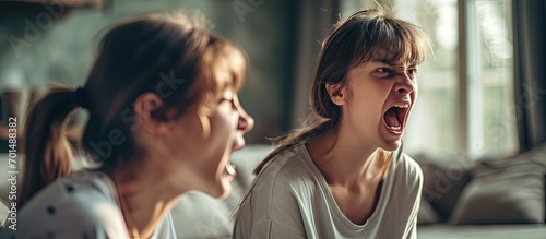 Teenage girl in difficult mood with angry mom. Creative Banner. Copyspace image photo