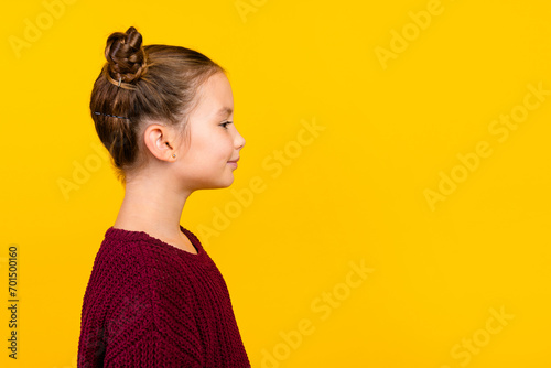Profile portrait of positive nice schoolchild look empty space advert blank isolated on yellow color background
