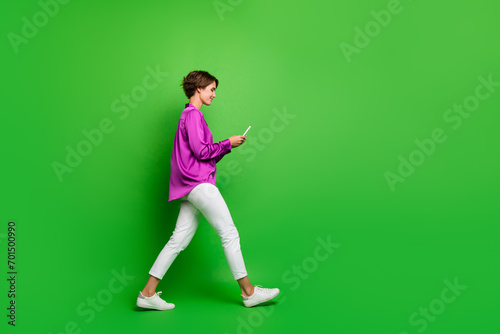 Profile side photo of gorgeous stunning girl dressed stylish clothes writing answer comment empty space isolated on green color background © deagreez