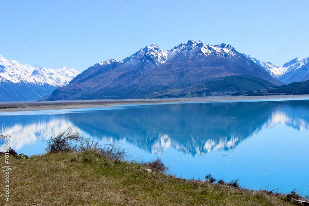 New zealand mirror lake blue and mountains in the back brown in the front