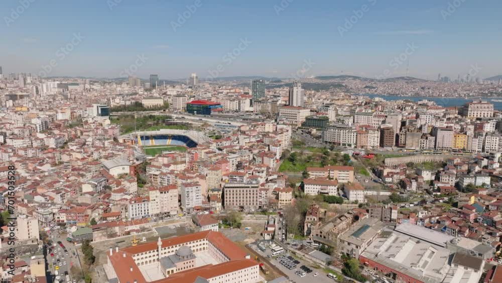 Fly above large city on sunny day. Dense town development in urban borough. Residential multistorey houses and sports stadium. Istanbul, Turkey Fly above large city on sunny day. Dense town development in urban borough. Residential multistorey houses and sports stadium. Istanbul, Turkey