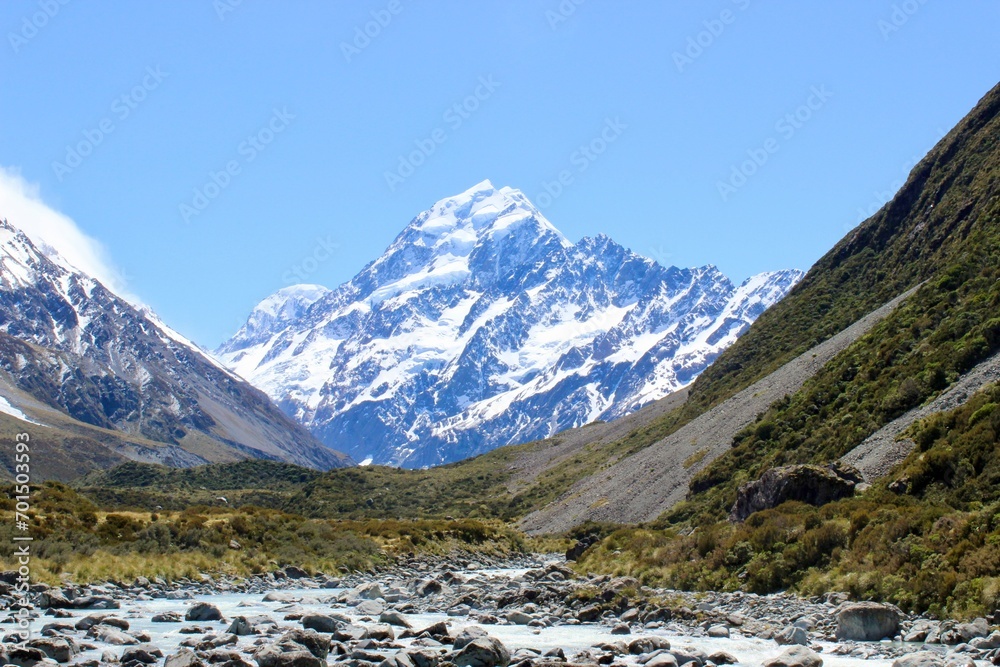 New Zealand mountains with snow green landscape and water river in front