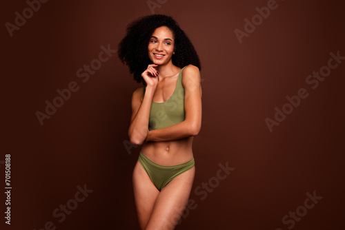 No filter studio photo of dreamy cute woman wear lingerie enjoy herself looking empty space isolated brown color background © deagreez