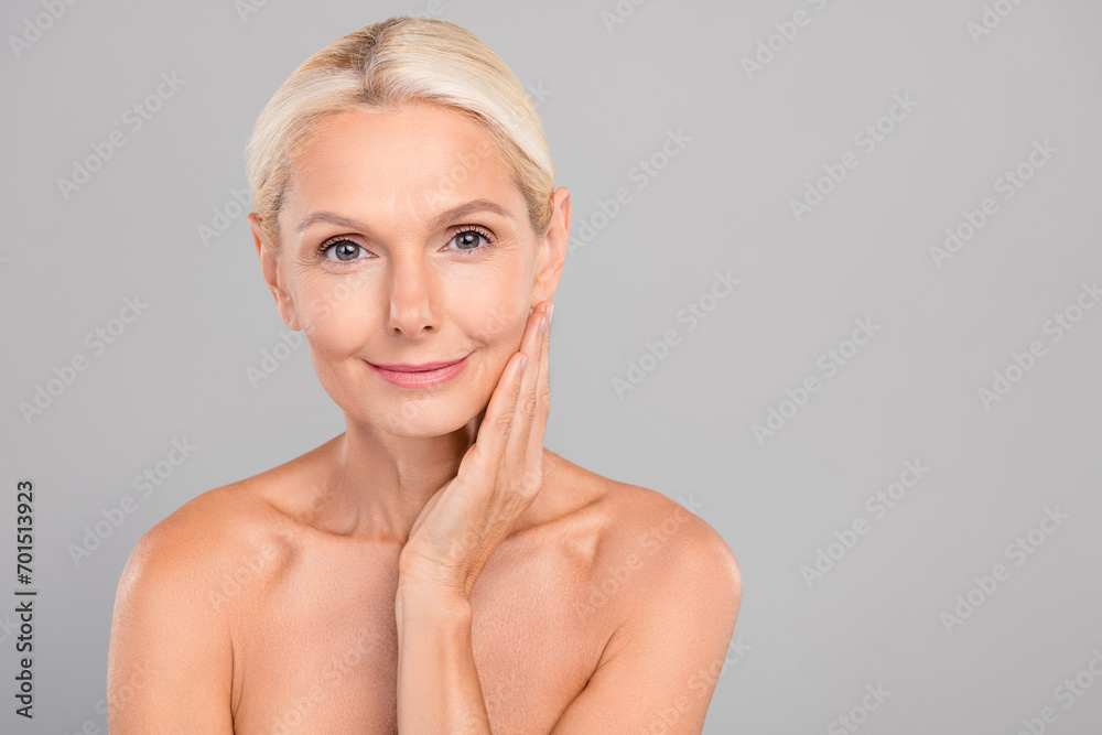 Portrait of happy smiling pensioner touch skin after peeling apply cleansing gel soft face empty space isolated on gray color background Portrait of happy smiling pensioner touch skin after peeling apply cleansing gel soft face empty space isolated on gray color background