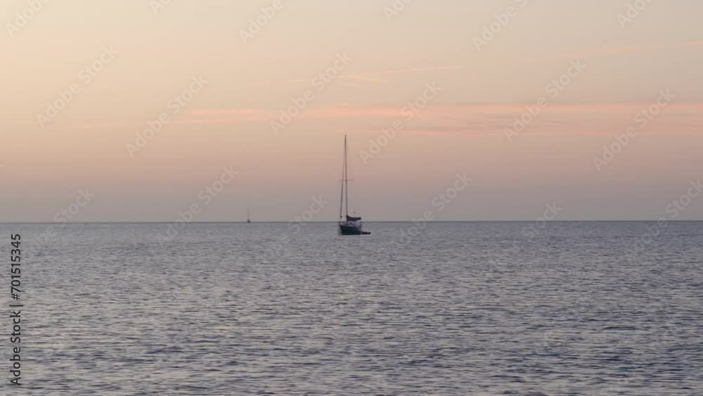 Sailboat sailing in the sea during a sunset Sailboat sailing in the sea during a sunset