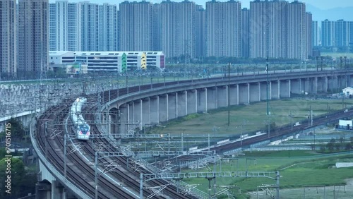 high speed train running on elevated railtrack photo