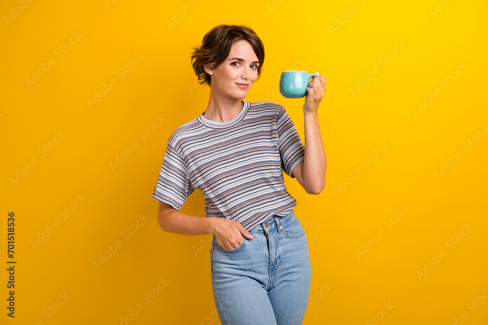 Photo of pretty lovely cheerful girl hold cup aromatic tasty coffee isolated on yellow color background Photo of pretty lovely cheerful girl hold cup aromatic tasty coffee isolated on yellow color background