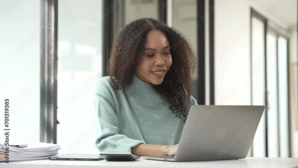 African American university student focused on working on her MBA project on a laptop in a study area. African American university student focused on working on her MBA project on a laptop in a study area.