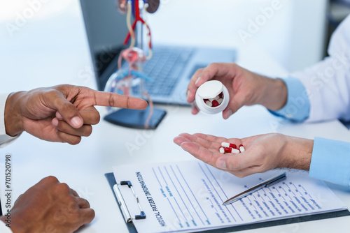 Doctor hands holding sectional model of prostate gland while male patient observes, suggesting discussion about prostate cancer, cystitis, urinary tract infection, potential medicines for treatment.