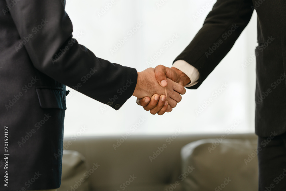 close-up of two men in business suits shaking hands, likely concluding a discussion or agreement, possibly in fields such as stock market investment, law, or real estate. close-up of two men in business suits shaking hands, likely concluding a discussion or agreement, possibly in fields such as stock market investment, law, or real estate.