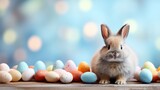  a rabbit sitting in front of a group of colored eggs on a wooden table with boke of blurry boke boke boke boke boke boke boke boke boke bokes in the background.