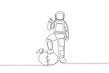 Continuous one line drawing astronaut stands with thumbs up pose and steps on money bag with one of foot. Give ready sign for expedition. Cosmonaut space. Single line draw design vector illustration