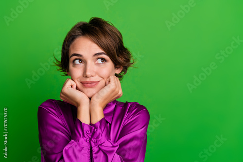 Photo of thoughtful lovely lady wear purple clothes arms under chin look up poster news empty space isolated on green color background