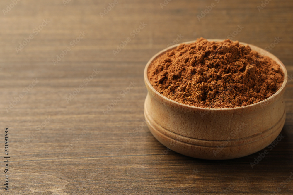 Aromatic cinnamon powder on wooden table, closeup. Space for text Aromatic cinnamon powder on wooden table, closeup. Space for text