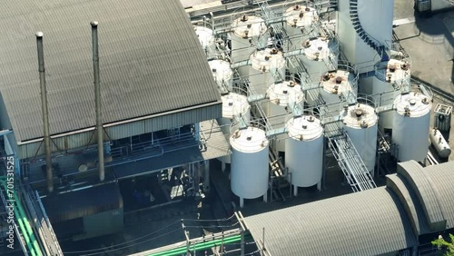 A diesel and biodiesel refinery as a fuel magician's workshop, It turns raw oil and eco-friendly oils into powerful, green energy. Transportation and energy concept. Bird's eye view by drone.
 photo